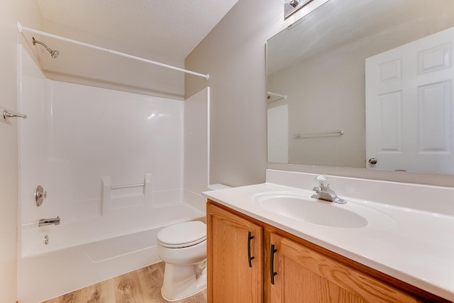 7539 Derby Ln, Shakopee, MN 55379 - bathroom with toilet, vanity, bathtub / shower combination, wood finished floors, and a textured ceiling