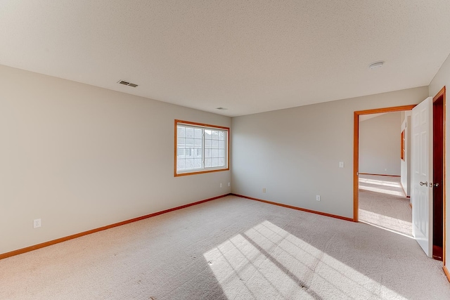7539 Derby Ln, Shakopee, MN 55379 - spare room with light carpet, a textured ceiling, and baseboards