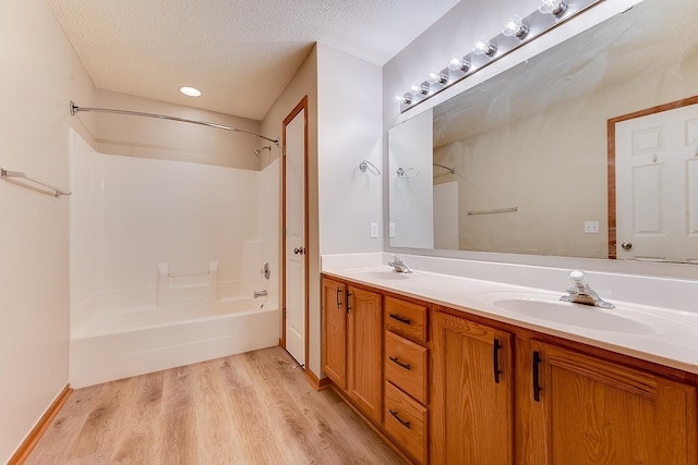 7539 Derby Ln, Shakopee, MN 55379 - full bath featuring double vanity, bathtub / shower combination, wood finished floors, and a textured ceiling