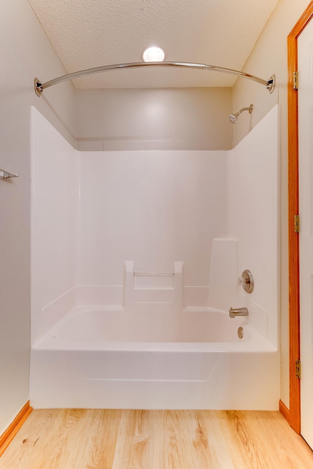 7539 Derby Ln, Shakopee, MN 55379 - full bathroom featuring shower / bathtub combination, wood finished floors, and baseboards