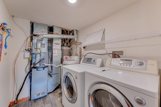 7539 Derby Ln, Shakopee, MN 55379 - laundry area featuring washer and clothes dryer, light wood-type flooring, and water heater
