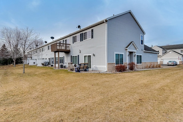 7539 Derby Ln, Shakopee, MN 55379 - rear view of house with a lawn, a balcony, and brick siding