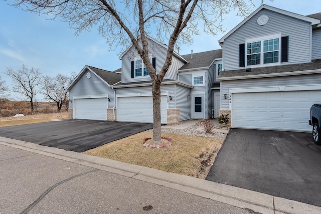 7539 Derby Ln, Shakopee, MN 55379 - traditional home with asphalt driveway, an attached garage, and brick siding