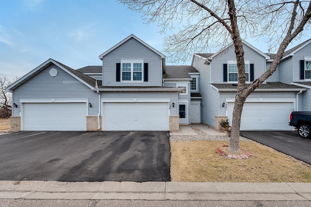 7539 Derby Ln, Shakopee, MN 55379 - view of front of property with asphalt driveway, brick siding, roof with shingles, and an attached garage