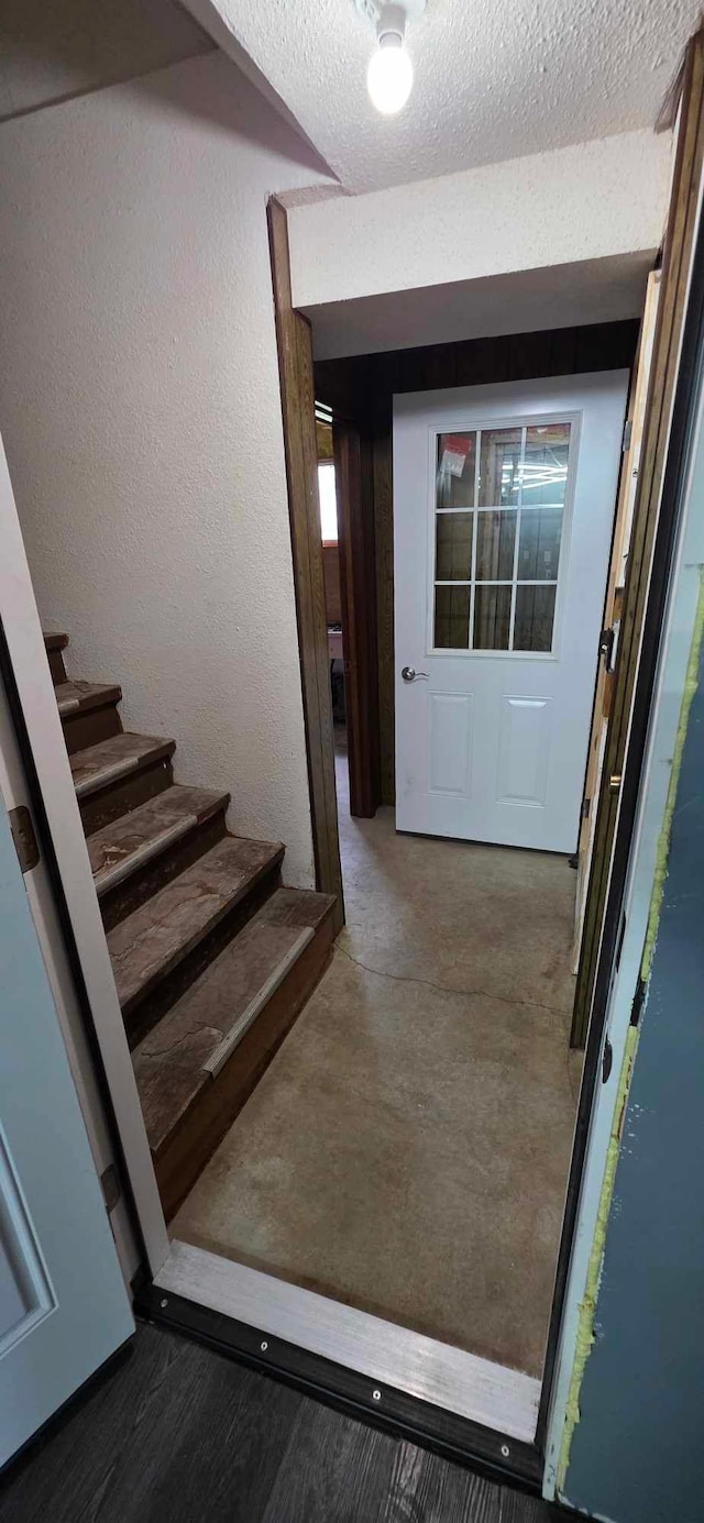 17548 749th Ave, Albert Lea Twp, MN 56007 - stairs with a textured ceiling and a textured wall