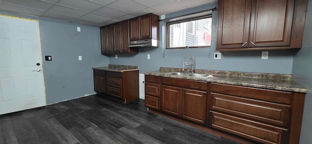 17548 749th Ave, Albert Lea Twp, MN 56007 - kitchen featuring a sink, dark wood-style flooring, under cabinet range hood, a drop ceiling, and dark countertops