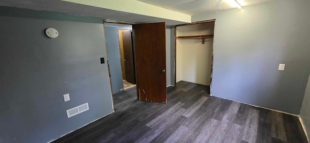 17548 749th Ave, Albert Lea Twp, MN 56007 - unfurnished bedroom with dark wood-type flooring and a closet