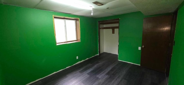17548 749th Ave, Albert Lea Twp, MN 56007 - unfurnished bedroom with dark wood-style floors, baseboards, and a closet