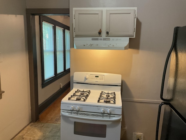 2430 Logan Ave N, Minneapolis, MN 55411 - kitchen with gas range gas stove, extractor fan, and freestanding refrigerator