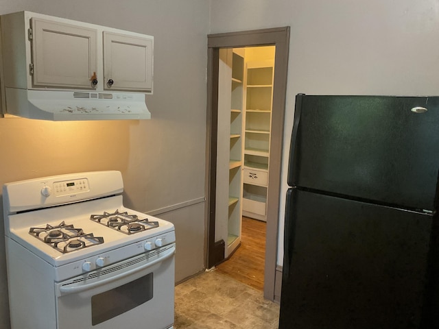 2430 Logan Ave N, Minneapolis, MN 55411 - kitchen with freestanding refrigerator, white gas range, and under cabinet range hood