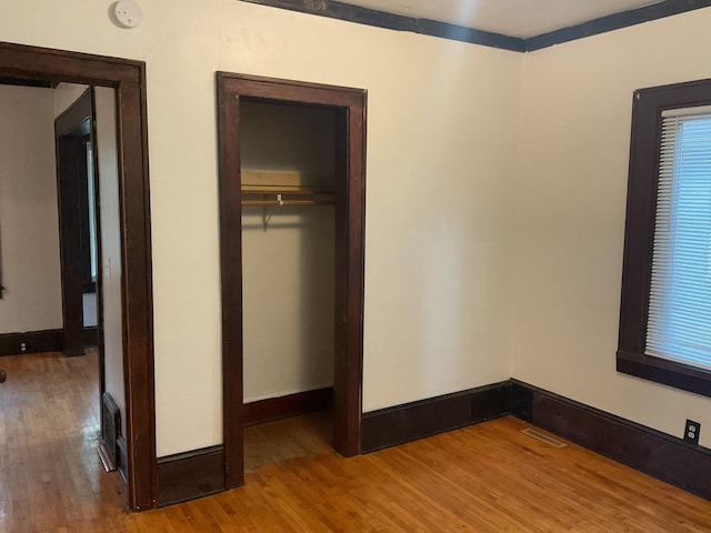 2430 Logan Ave N, Minneapolis, MN 55411 - unfurnished bedroom with wood finished floors, a closet, and baseboards