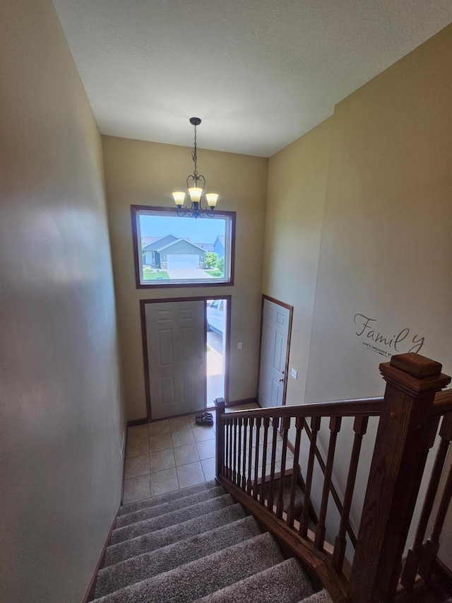3657 46th Ave NW, Rochester, MN 55901 - staircase with a chandelier, tile patterned flooring, baseboards, and a high ceiling