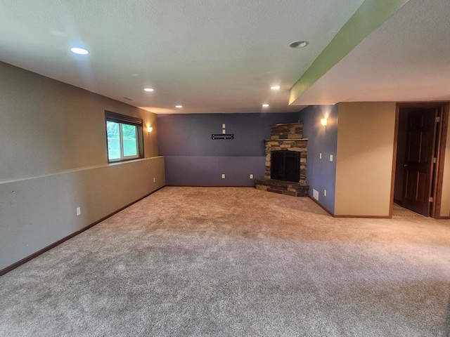 3657 46th Ave NW, Rochester, MN 55901 - unfurnished living room featuring carpet flooring, recessed lighting, baseboards, and a stone fireplace