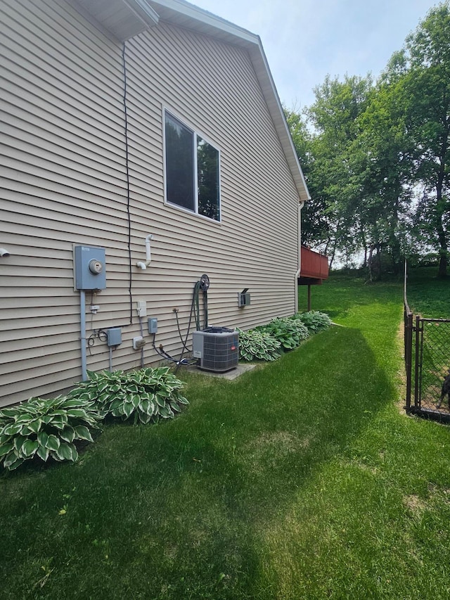 3657 46th Ave NW, Rochester, MN 55901 - view of side of home featuring a yard and cooling unit
