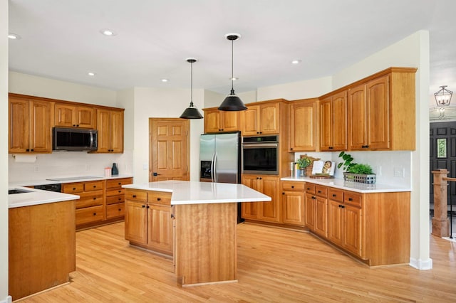 18510 Pheasant Ridge Rd, Credit River Twp, MN 55372 - kitchen featuring appliances with stainless steel finishes, decorative backsplash, a kitchen island, light wood finished floors, and light countertops