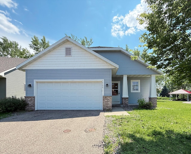 3100 212th St W, Farmington, MN 55024 - craftsman house featuring asphalt driveway, a garage, a front yard, and brick siding