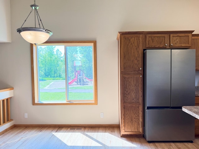3100 212th St W, Farmington, MN 55024 - kitchen with freestanding refrigerator, light wood-style floors, baseboards, and decorative light fixtures