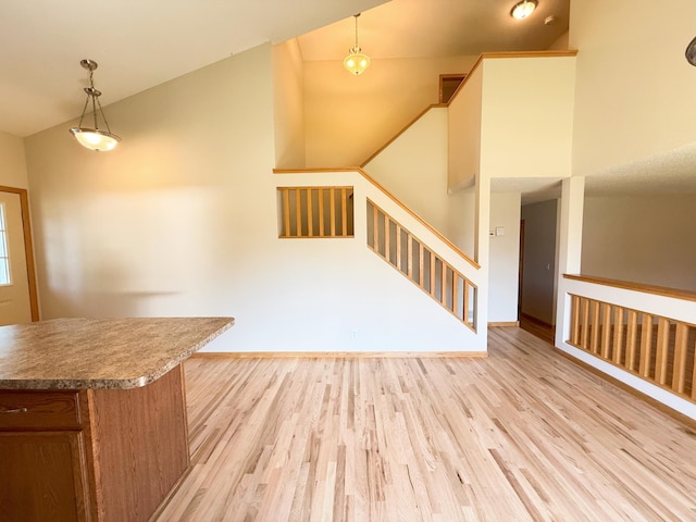 3100 212th St W, Farmington, MN 55024 - unfurnished living room with light wood finished floors, stairs, and lofted ceiling