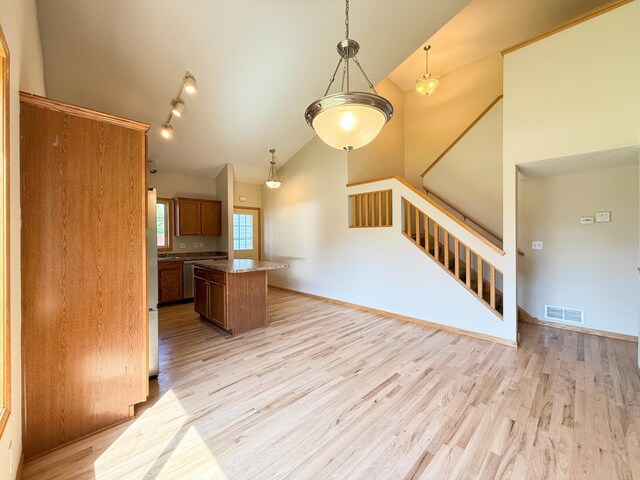 3100 212th St W, Farmington, MN 55024 - kitchen featuring a kitchen island, high vaulted ceiling, light wood-type flooring, pendant lighting, and open floor plan