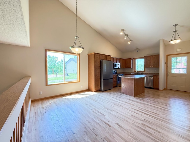 3100 212th St W, Farmington, MN 55024 - kitchen with appliances with stainless steel finishes, high vaulted ceiling, light wood-style flooring, baseboards, and decorative light fixtures