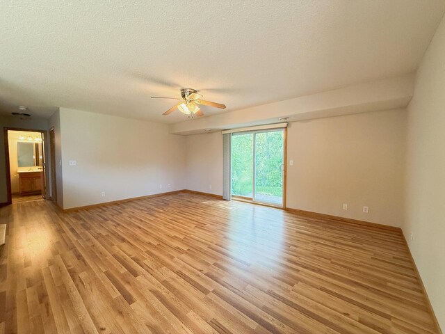 3100 212th St W, Farmington, MN 55024 - spare room featuring ceiling fan, light wood-type flooring, a textured ceiling, and baseboards