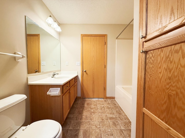 3100 212th St W, Farmington, MN 55024 - full bath with toilet, vanity, shower / washtub combination, stone finish floors, and a textured ceiling