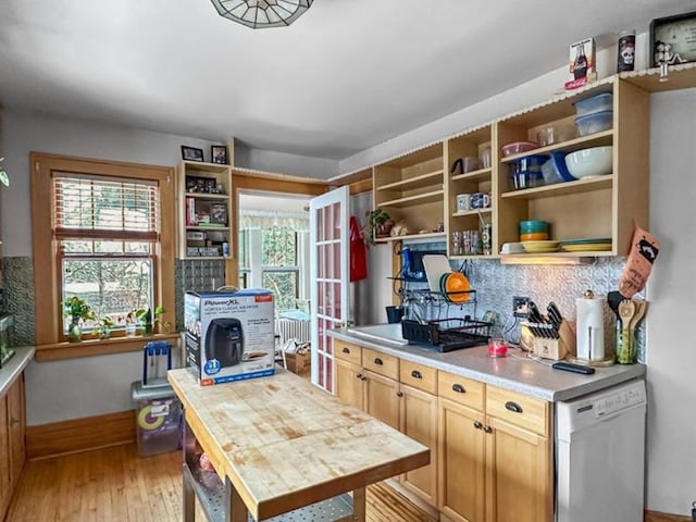 836 Thornton St SE, Minneapolis, MN 55414 - kitchen featuring dishwashing machine, open shelves, light wood-style floors, tasteful backsplash, and baseboards