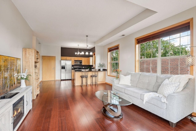 3310 Nicollet Ave Unit 302, Minneapolis, MN 55408 - living room featuring a chandelier, dark wood-style floors, and baseboards