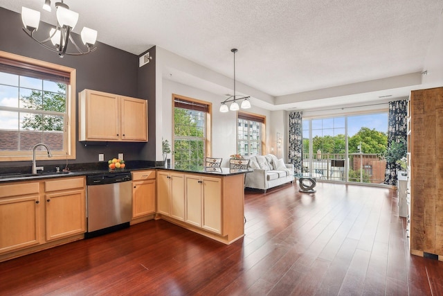3310 Nicollet Ave Unit 302, Minneapolis, MN 55408 - kitchen featuring stainless steel dishwasher, a sink, open floor plan, dark wood-style flooring, and dark countertops