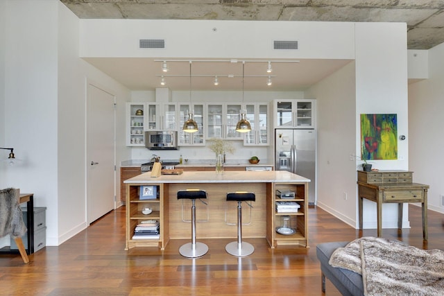 901 2nd St Unit 905, Minneapolis, MN 55415 - kitchen featuring stainless steel appliances, open shelves, dark wood-style flooring, and white cabinetry