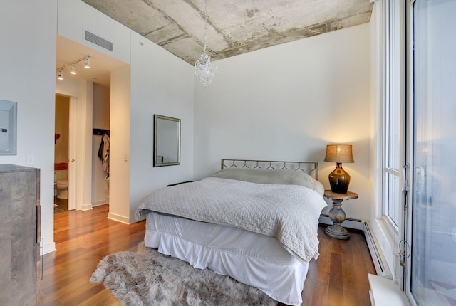 901 2nd St Unit 905, Minneapolis, MN 55415 - bedroom featuring wood finished floors, track lighting, and baseboard heating
