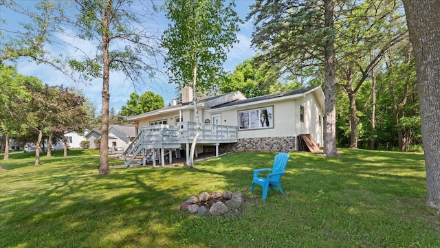 9803 287th Ave NW, Zimmerman, MN 55398 - rear view of house featuring a deck, a lawn, stairs, and a chimney
