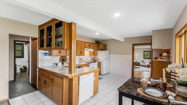 9803 287th Ave NW, Zimmerman, MN 55398 - kitchen featuring white appliances, light tile patterned flooring, under cabinet range hood, tile walls, and tile counters