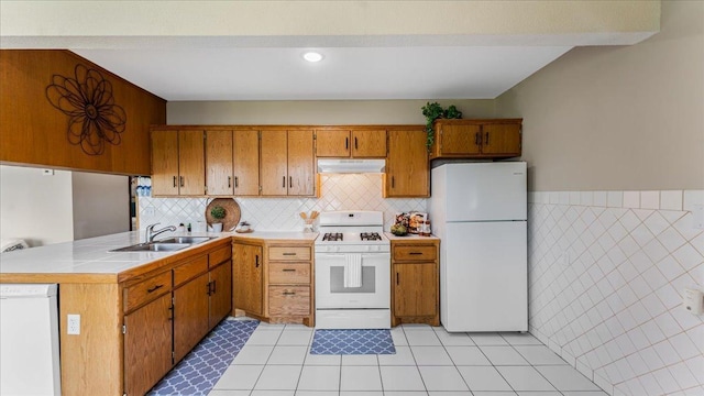 9803 287th Ave NW, Zimmerman, MN 55398 - kitchen featuring white appliances, a sink, brown cabinetry, under cabinet range hood, and light countertops