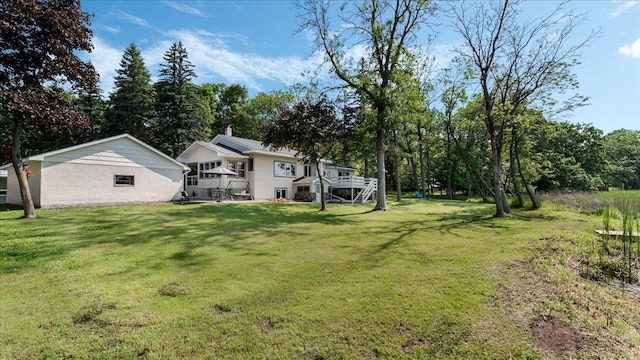 9803 287th Ave NW, Zimmerman, MN 55398 - view of grassy yard featuring a deck and stairway