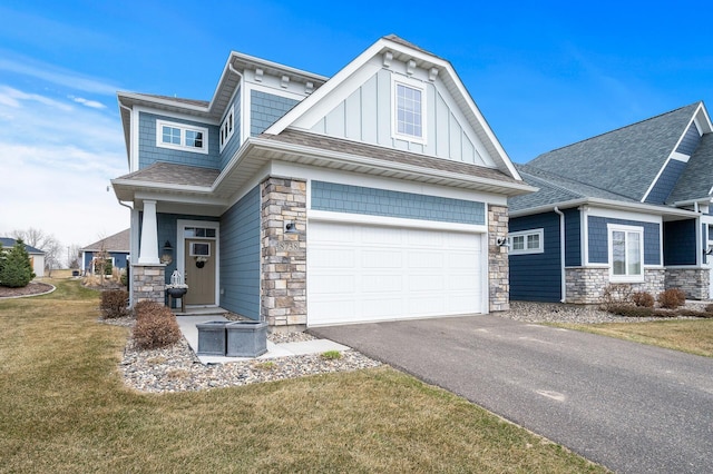 8738 Upper 9th Pl N, Lake Elmo, MN 55042 - craftsman-style home with stone siding, asphalt driveway, a front lawn, and a shingled roof