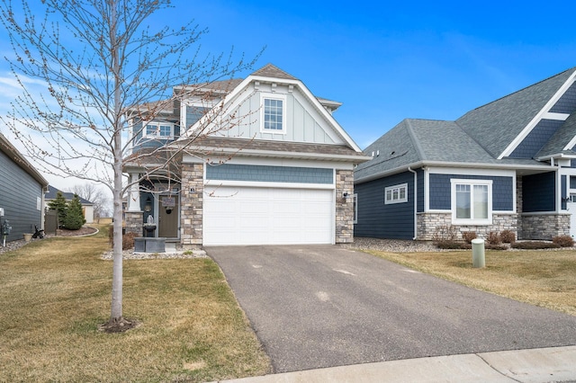 8738 Upper 9th Pl N, Lake Elmo, MN 55042 - view of front of house with stone siding, asphalt driveway, a front yard, and board and batten siding