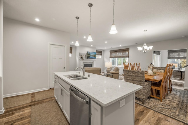 8738 Upper 9th Pl N, Lake Elmo, MN 55042 - kitchen with stainless steel dishwasher, a sink, wood finished floors, a fireplace, and recessed lighting