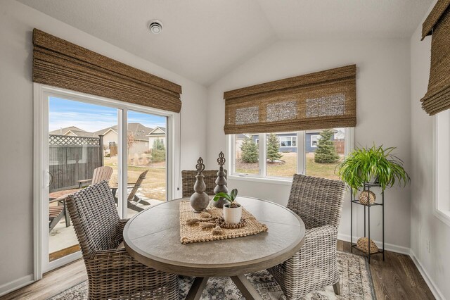 8738 Upper 9th Pl N, Lake Elmo, MN 55042 - dining space with light wood-style flooring, lofted ceiling, and baseboards