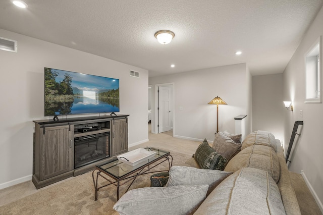 8738 Upper 9th Pl N, Lake Elmo, MN 55042 - living area featuring light colored carpet, a glass covered fireplace, recessed lighting, baseboards, and a textured ceiling