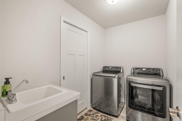8738 Upper 9th Pl N, Lake Elmo, MN 55042 - laundry area featuring washer and clothes dryer and a textured ceiling