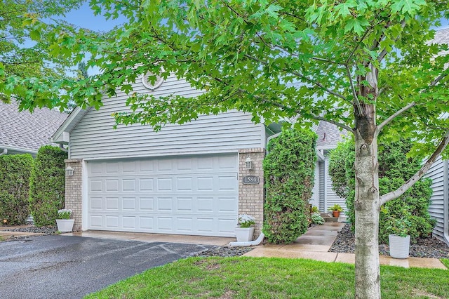 1584 126th Ln NW, Coon Rapids, MN 55448 - view of front of property with brick siding and asphalt driveway