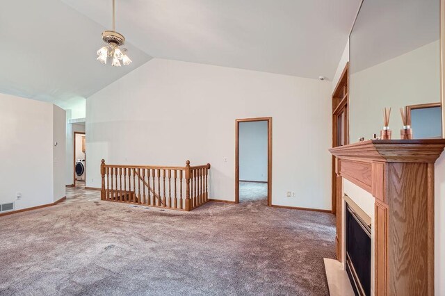 1584 126th Ln NW, Coon Rapids, MN 55448 - bonus room featuring vaulted ceiling, washer / clothes dryer, carpet flooring, and a fireplace with flush hearth