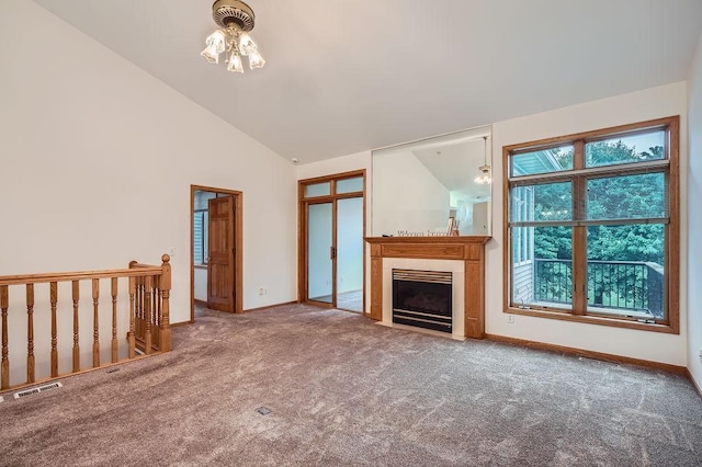 1584 126th Ln NW, Coon Rapids, MN 55448 - unfurnished living room featuring carpet, a chandelier, a fireplace with flush hearth, and high vaulted ceiling