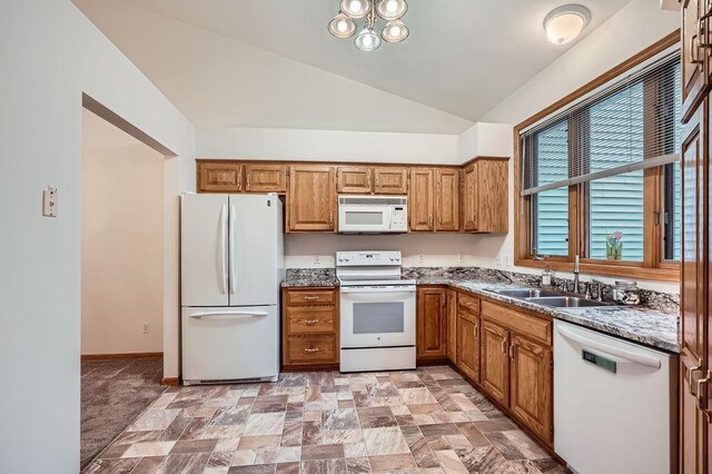 1584 126th Ln NW, Coon Rapids, MN 55448 - kitchen with white appliances, lofted ceiling, brown cabinets, and stone finish floors