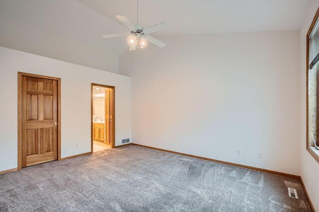 1584 126th Ln NW, Coon Rapids, MN 55448 - unfurnished bedroom featuring light carpet, high vaulted ceiling, connected bathroom, and ceiling fan