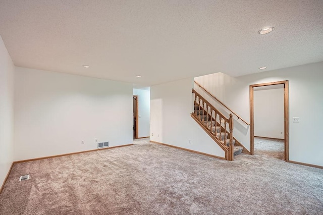 1584 126th Ln NW, Coon Rapids, MN 55448 - unfurnished living room featuring carpet floors, stairs, recessed lighting, and a textured ceiling