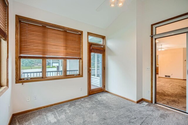 1584 126th Ln NW, Coon Rapids, MN 55448 - carpeted spare room featuring lofted ceiling and ceiling fan