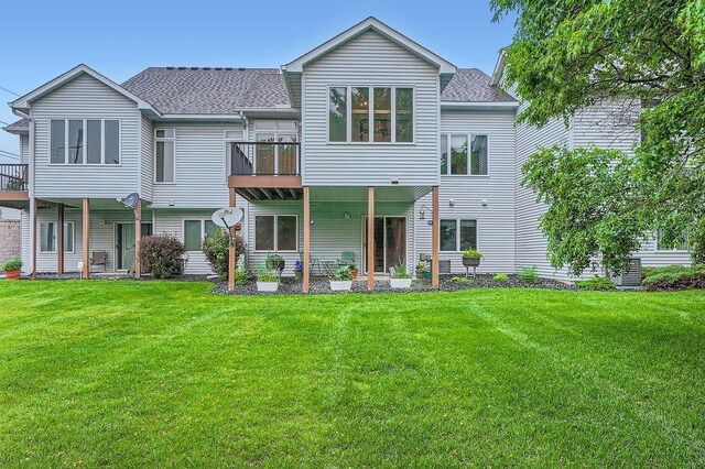 1584 126th Ln NW, Coon Rapids, MN 55448 - rear view of property featuring a yard and a shingled roof