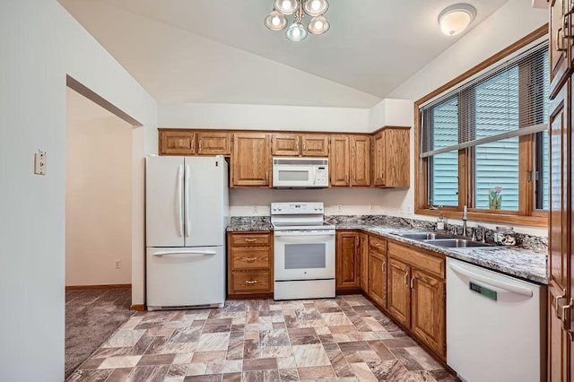 1584 126th Ln NW, Coon Rapids, MN 55448 - kitchen featuring white appliances, vaulted ceiling, brown cabinetry, and stone finish floors